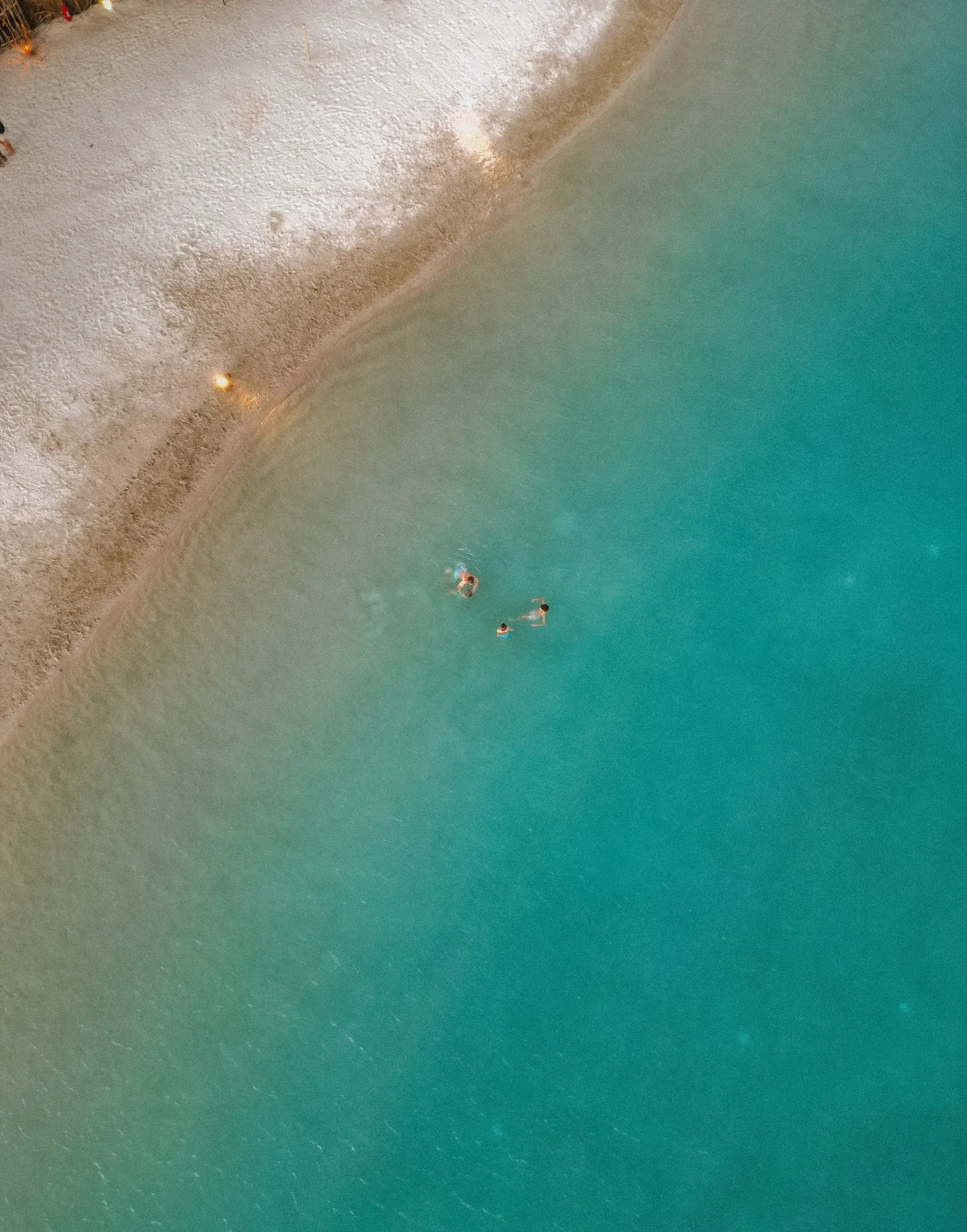 Aerial view of turquoise water and white sand