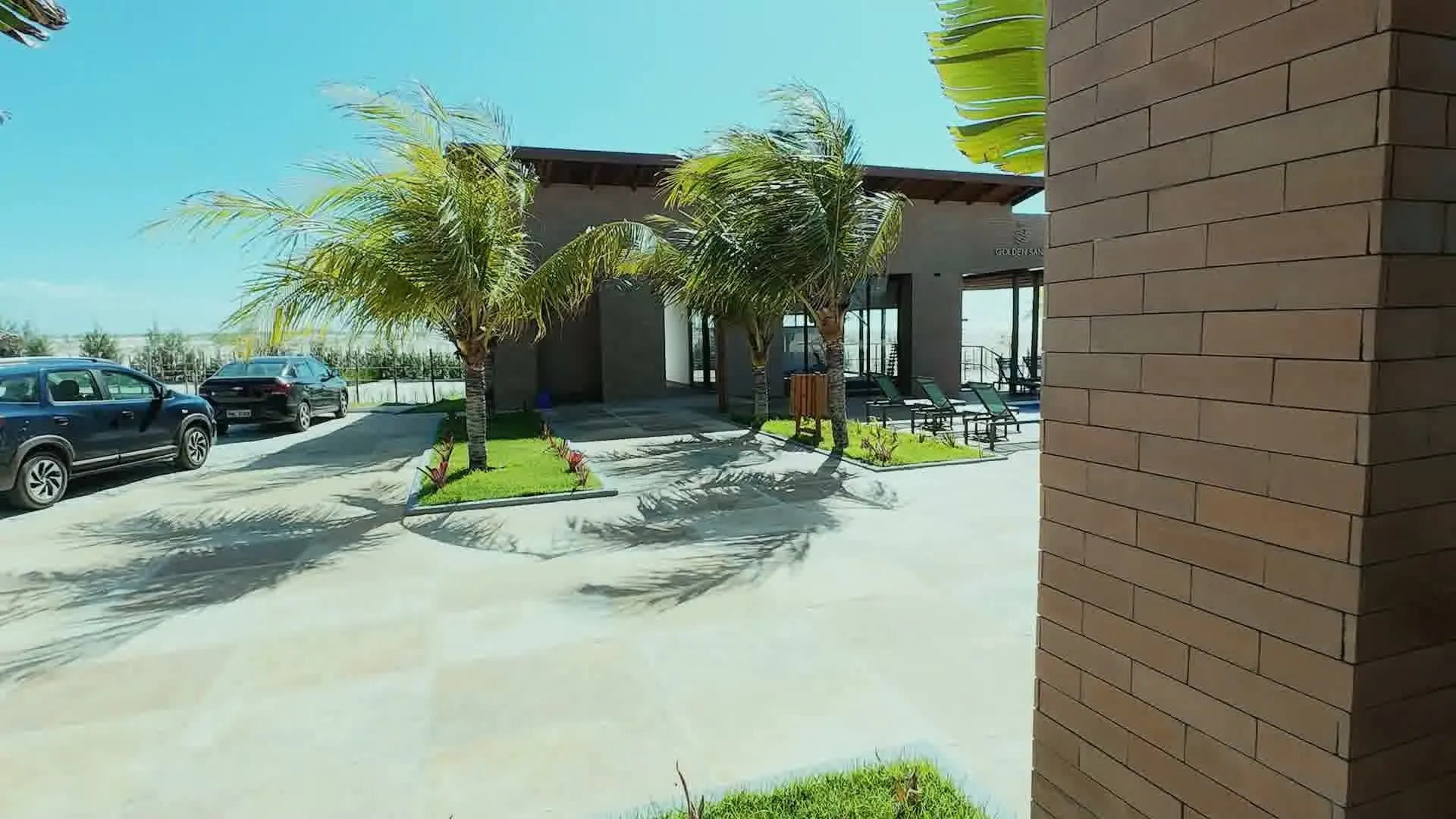 The clubhouse entrance with palms