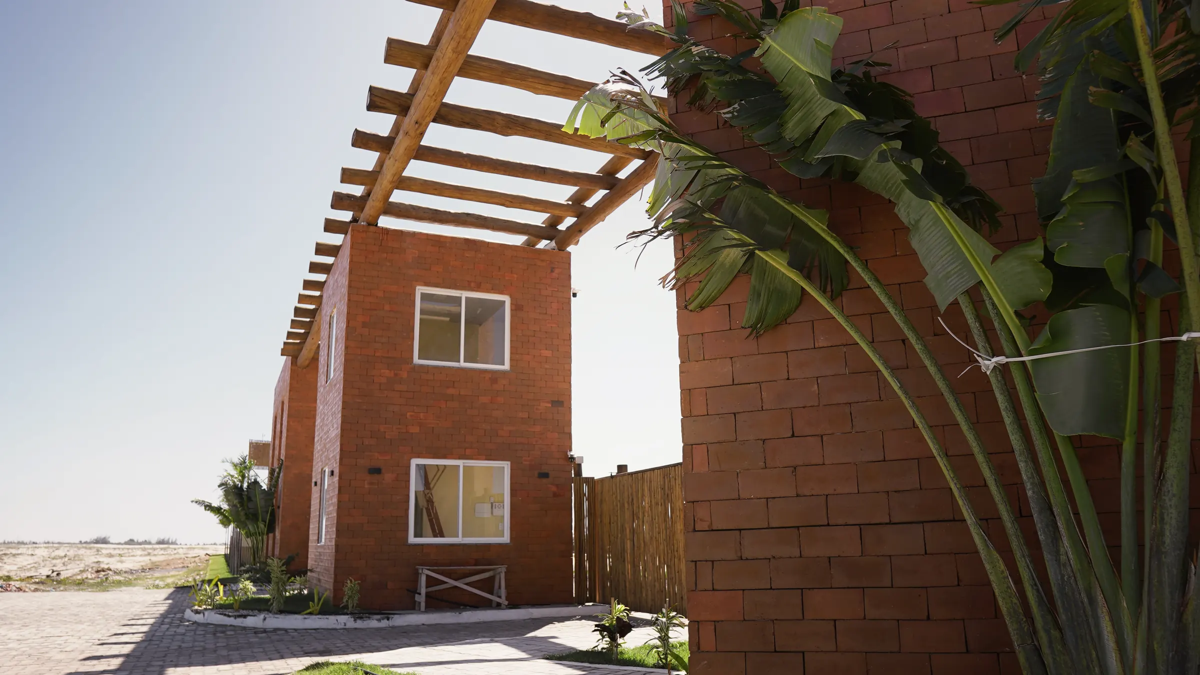 A brick house with a pergola at Golden Sand