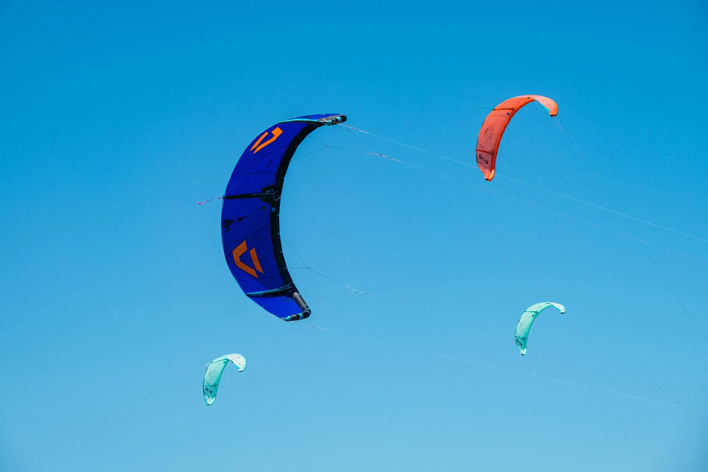 Colourful kites against a blue sky