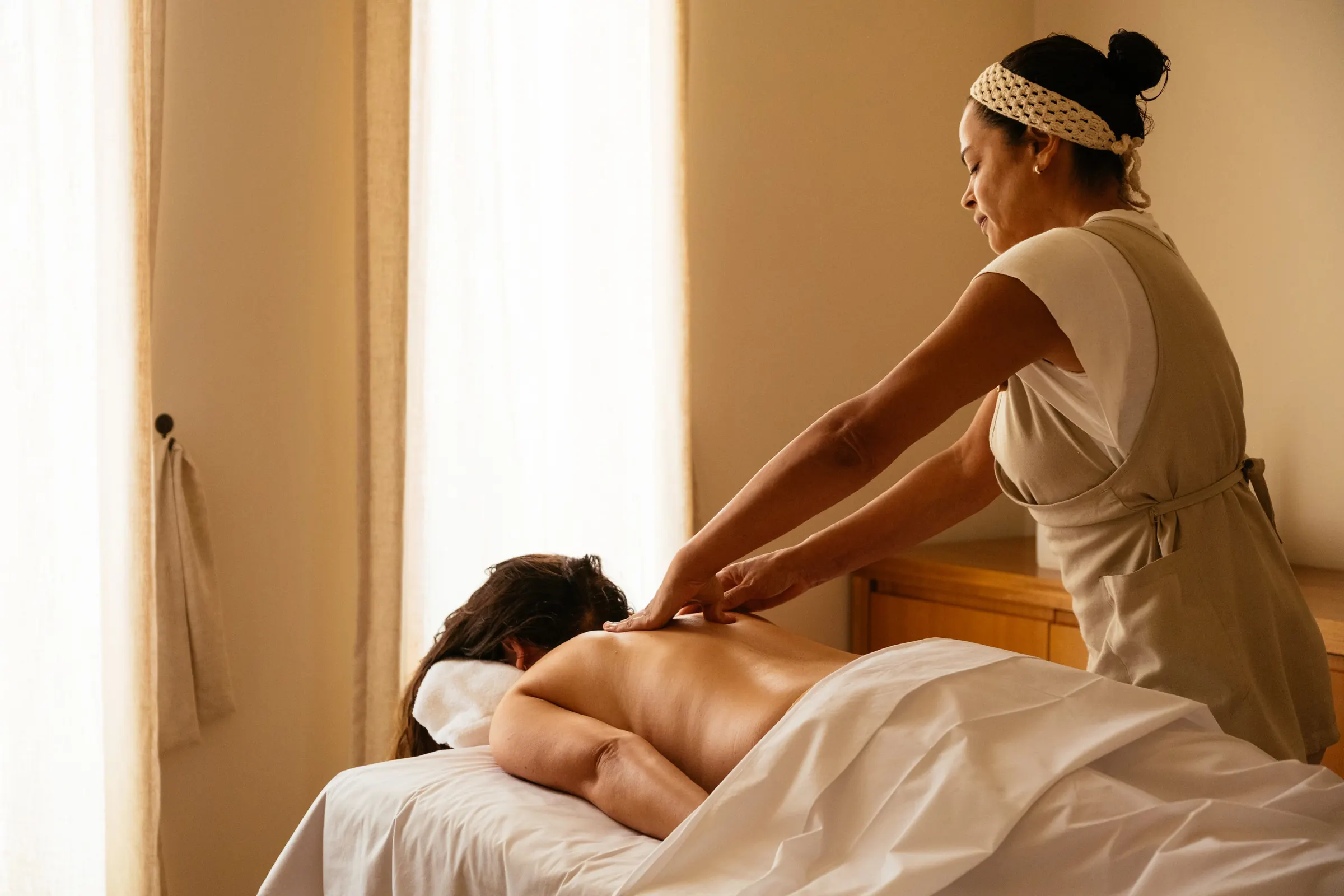 A massage at the spa, in a room with natural light